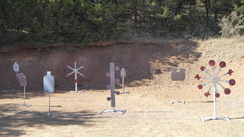 Reactive steel target plate bay for handgun cartridges and shotgun.  Texas Stars, Dueling tree and hostage paddle targets.